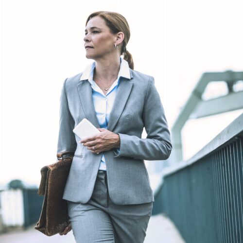 Businesswoman walking on bridge