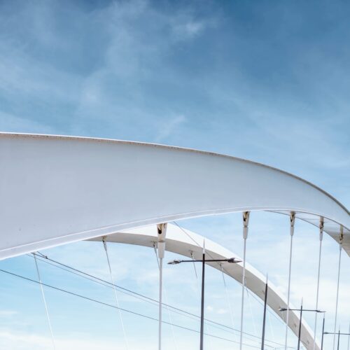 Geometrical view on the modern bridge on the blue sky background